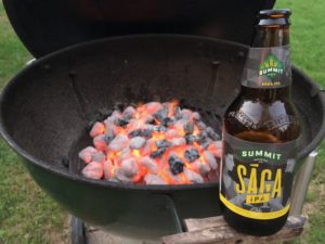 Summit Beer Saga IPA in 12oz bottle by grill.