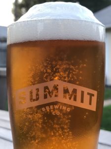 Summit beer in glass outside